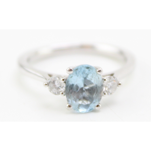 222 - A platinum, aquamarine and diamond dress ring, the oval cut stone 7.9 by 6.1mm, flanked by a diamond... 