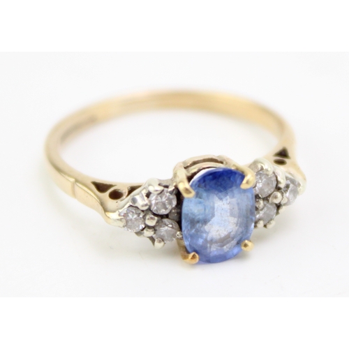 224 - A 9ct gold, sapphire and diamond dress ring, the central oval cut pale cornflower blue stone of appr... 