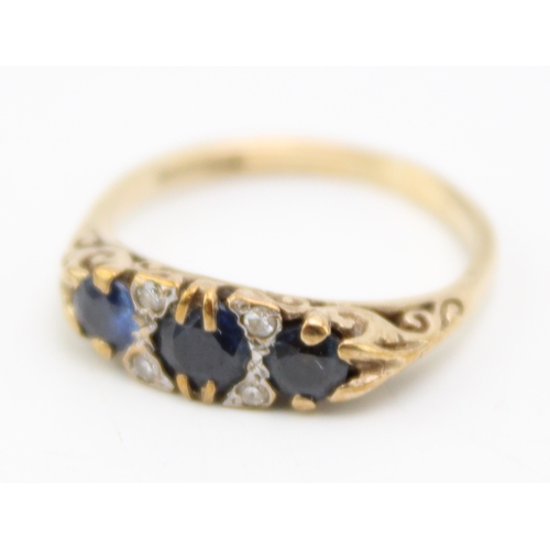 225 - A 9ct gold, sapphire and diamond three stone ring, set with three deep royal blue sapphires, the lar... 