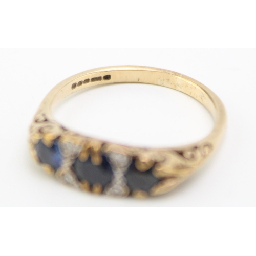 225 - A 9ct gold, sapphire and diamond three stone ring, set with three deep royal blue sapphires, the lar... 