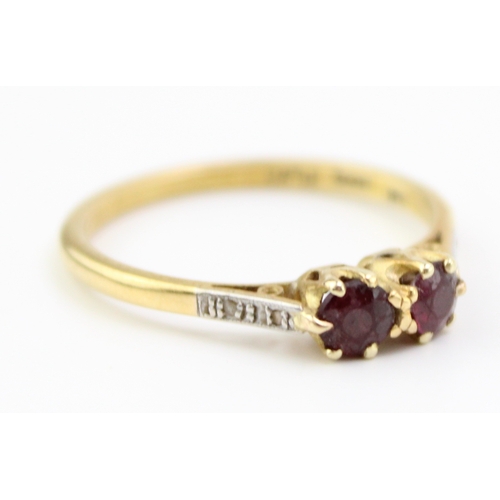 239 - 18ct gold and platinum two stone ring, set garnets with diamonds to the shoulder, 2.8g, size S.