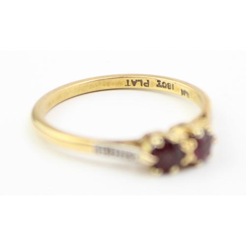 239 - 18ct gold and platinum two stone ring, set garnets with diamonds to the shoulder, 2.8g, size S.