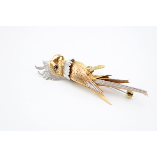 242 - A white and yellow gold brooch modelled as a cockatoo perched on a branch with sapphire eye, with te... 