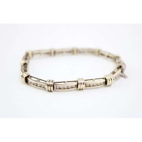 243 - An 18ct gold and diamond bracelet, of eleven panels each with five channel set diamonds, each diamon... 