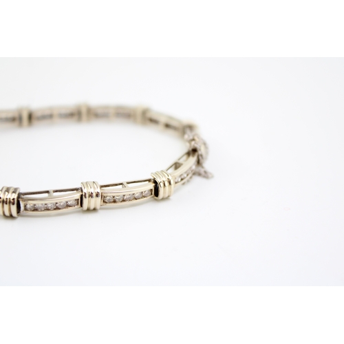 243 - An 18ct gold and diamond bracelet, of eleven panels each with five channel set diamonds, each diamon... 