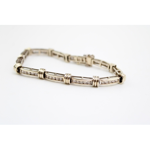 243 - An 18ct gold and diamond bracelet, of eleven panels each with five channel set diamonds, each diamon... 