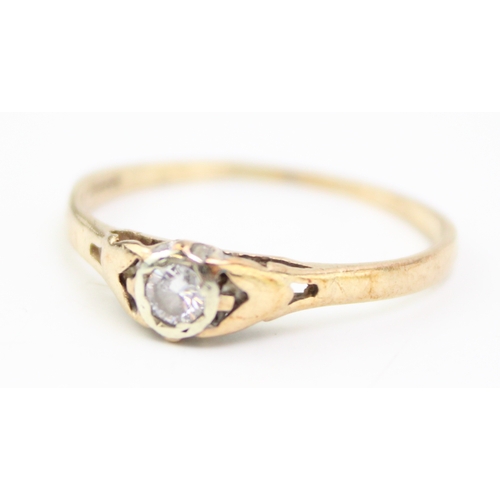 245 - 9ct gold diamond solitaire ring, stone is approx. 1/10ct, in rub over setting, size Q, 1.3g.