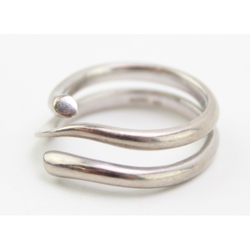 249 - An 18ct white gold 'Magic' ring, by Georg Jensen,
of coiled court section form, with a knife edge ce... 