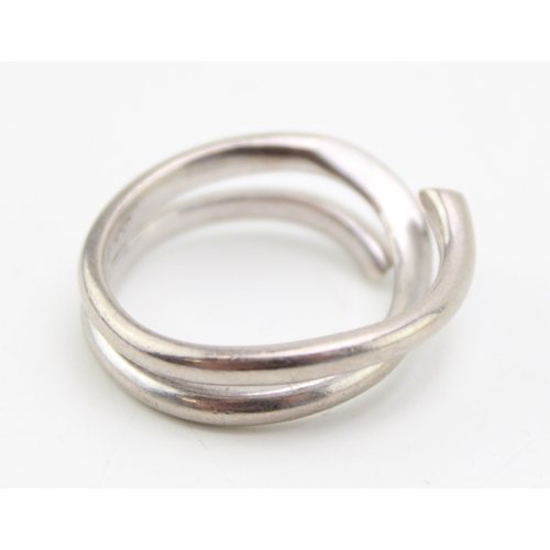 249 - An 18ct white gold 'Magic' ring, by Georg Jensen,
of coiled court section form, with a knife edge ce... 