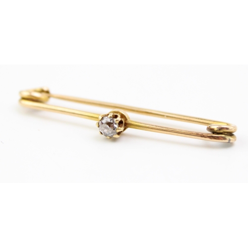 262 - A gold and diamond bar or pin brooch, set with a single diamond of approximately 0.1ct, 3.6mm diamet... 