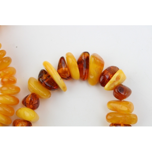 263 - Two strings of butterscotch and clear amber, comprising a string of uneven button beads, total weigh... 