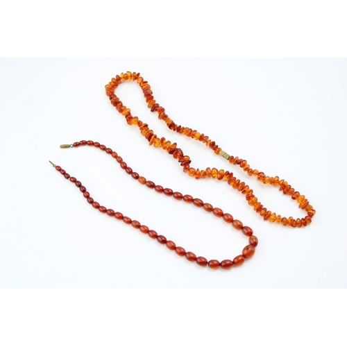 269 - Two strings of clear cognac amber, comprising a string of oval beads, 8.7g, and another of naturalis... 