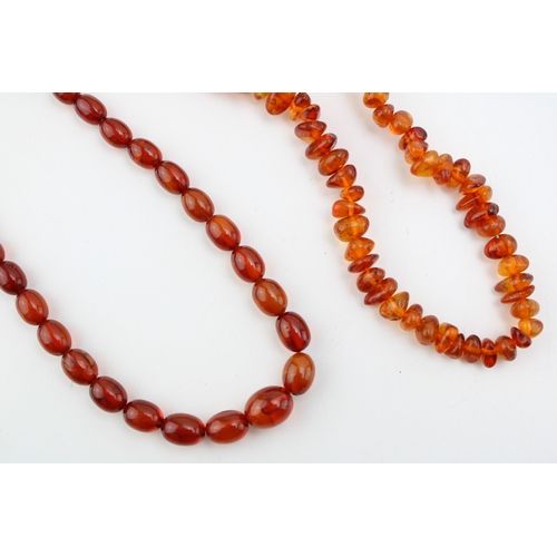 269 - Two strings of clear cognac amber, comprising a string of oval beads, 8.7g, and another of naturalis... 