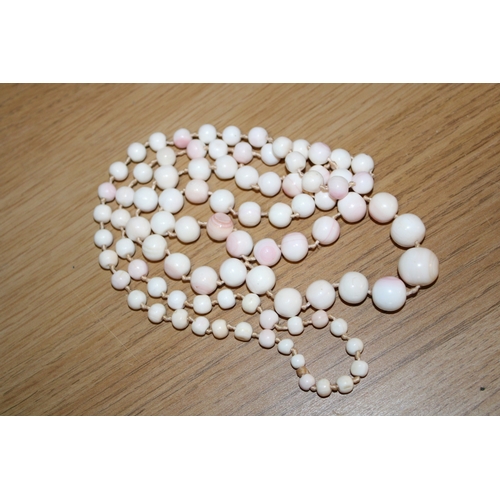 274 - A string of vintage pale angel coral beads of graduated spherical form, from 5.2 to 14.4mm diameter,... 