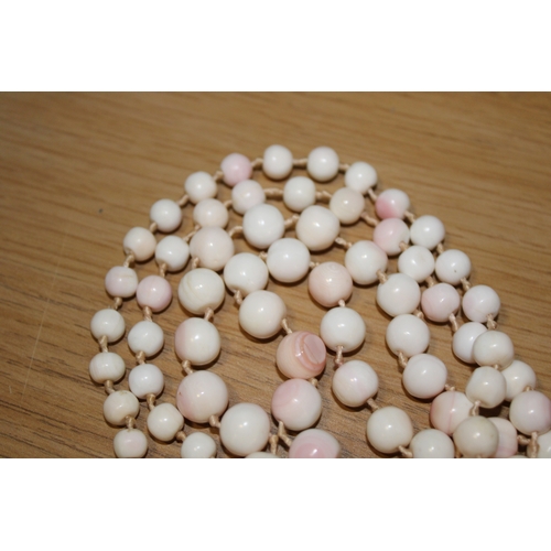 274 - A string of vintage pale angel coral beads of graduated spherical form, from 5.2 to 14.4mm diameter,... 