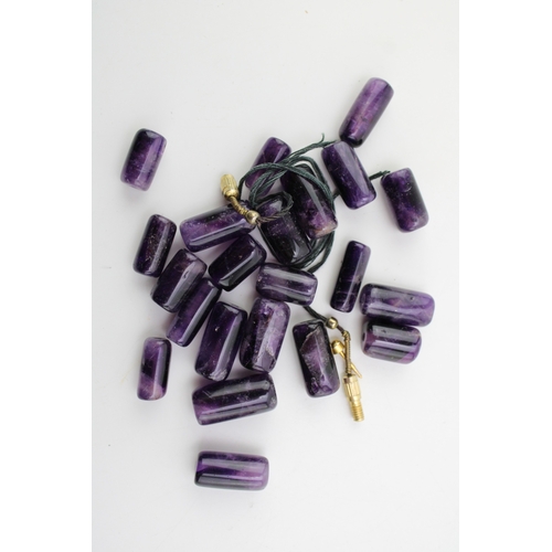 275 - A group of cylindrical polished amethyst beads, 53.9g total weight.