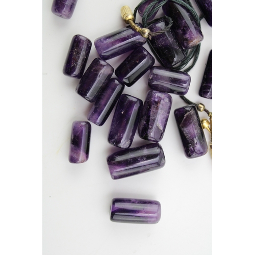 275 - A group of cylindrical polished amethyst beads, 53.9g total weight.