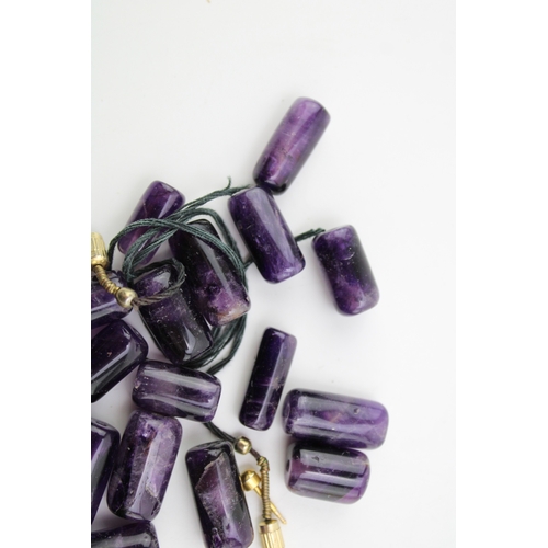 275 - A group of cylindrical polished amethyst beads, 53.9g total weight.