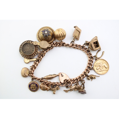 283 - A 9ct gold curb link charm bracelet with eighteen charms, including pyramid which opens to reveal mu... 