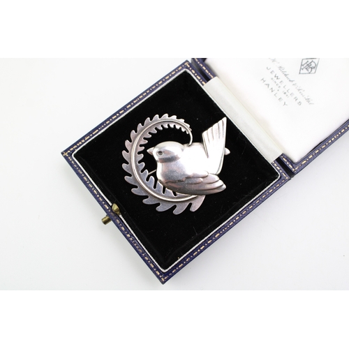 286 - A Georg Jensen robin brooch, number 309, designed by Arno Malinowski bird with a fern, fully stamped... 