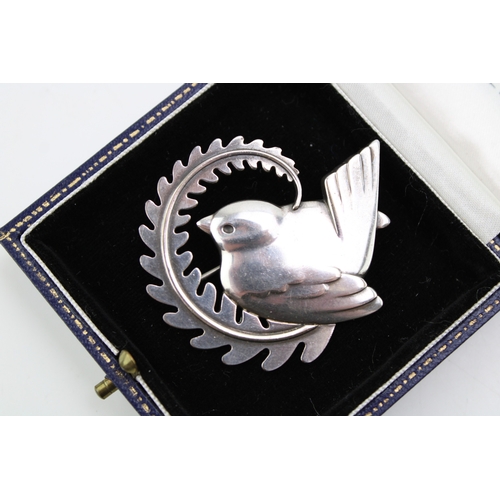 286 - A Georg Jensen robin brooch, number 309, designed by Arno Malinowski bird with a fern, fully stamped... 