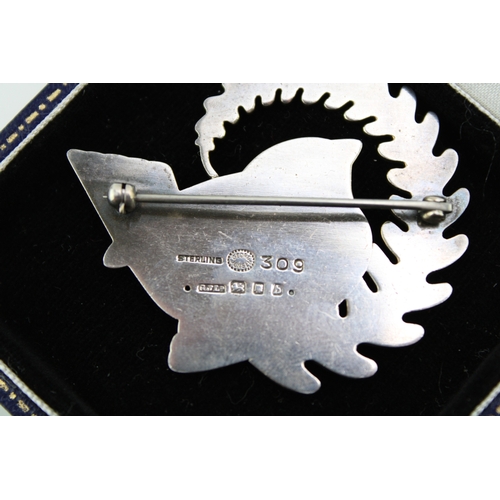 286 - A Georg Jensen robin brooch, number 309, designed by Arno Malinowski bird with a fern, fully stamped... 