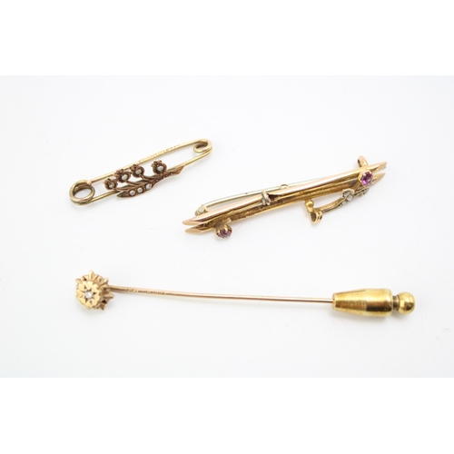 305 - Two 9ct gold sweetheart brooches, one a floral example set with seed pearls, the other set with rubi... 