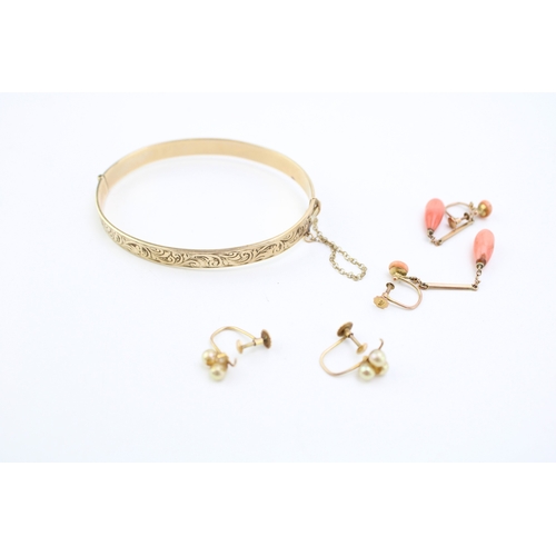 311 - Two pairs of 9ct yellow gold earrings to include a pair with coral beads and a pair with cultured pe... 