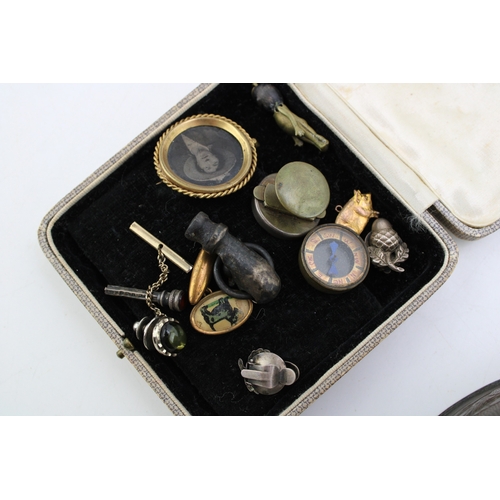 313 - An interesting collection of antique curios to include  miniature compass, silver acorn clip on earr... 