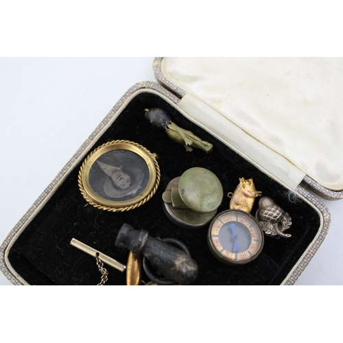 313 - An interesting collection of antique curios to include  miniature compass, silver acorn clip on earr... 