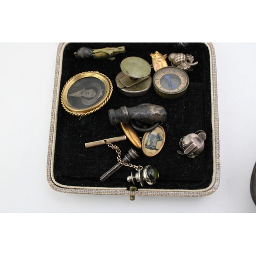 313 - An interesting collection of antique curios to include  miniature compass, silver acorn clip on earr... 