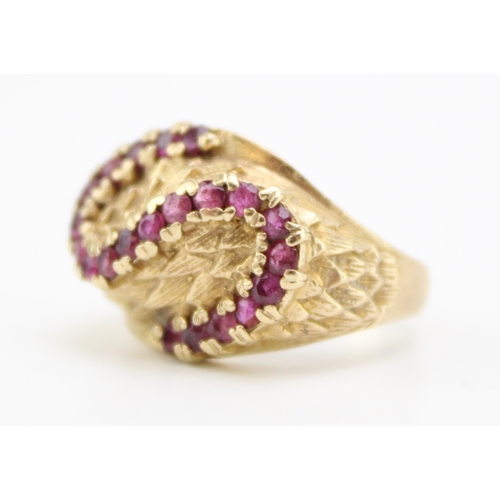 403 - 9ct gold and red stone ring set is the form of an S, size Q/P, 7.4g