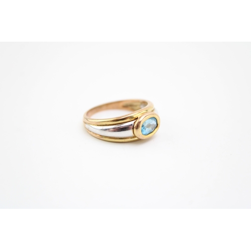 407 - 9ct yellow & white gold blue topaz set ring size P, 4.1g