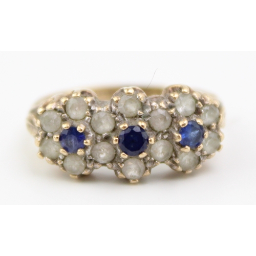 413 - 9ct gold blue & white stone set ring size M, 3.4g, flower head form.