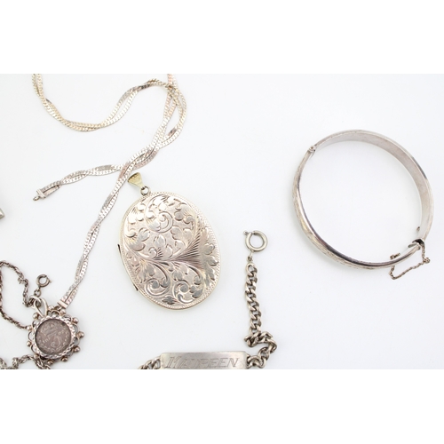 427 - Group of hallmarked sterling silver jewellery including locket, ingot, chain, ID bracelet, bangle, c... 