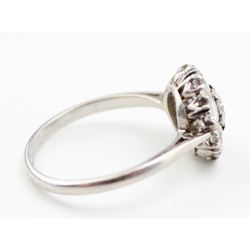 429 - An early Art Deco style diamond and platinum flowerhead ring, approximate diameter 4.9mm, surrounded... 