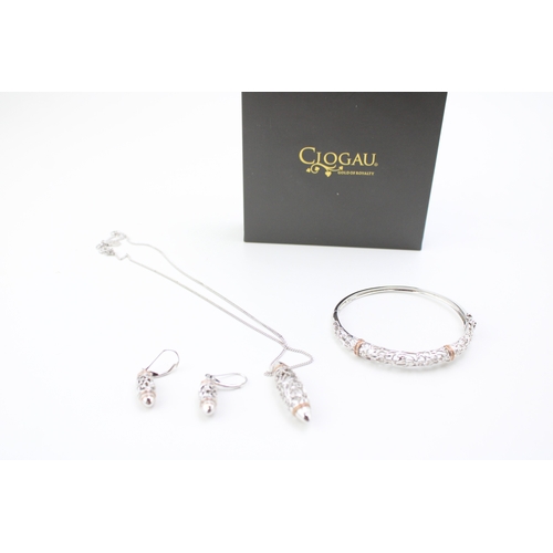 430 - A Clogau silver and gold suite of jewellery comprising bangle, pendant and earrrings, each of pierce... 