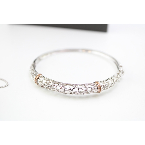 430 - A Clogau silver and gold suite of jewellery comprising bangle, pendant and earrrings, each of pierce... 