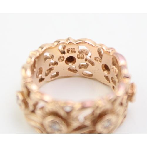 431 - A 14ct rose gold and diamond ring, the wide band 8.7mm, of pierced foliate design in the Welsh manne... 