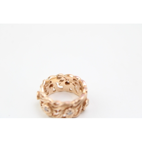 431 - A 14ct rose gold and diamond ring, the wide band 8.7mm, of pierced foliate design in the Welsh manne... 