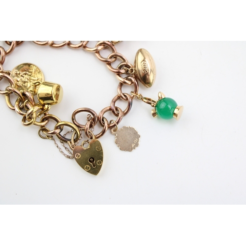 436 - A 9ct gold curb link charm bracelet with heart shaped padlock clasp and seven charms comprising kett... 