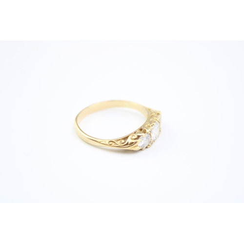 439 - An 18ct gold and diamond three stone dress ring, the central stone of approximately 5.7mm diameter, ... 