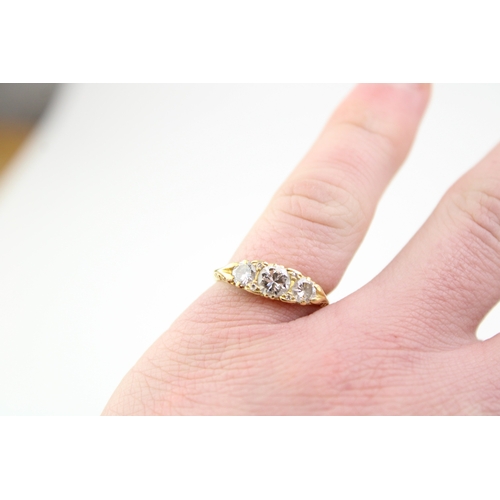 439 - An 18ct gold and diamond three stone dress ring, the central stone of approximately 5.7mm diameter, ... 