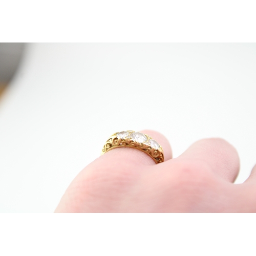 439 - An 18ct gold and diamond three stone dress ring, the central stone of approximately 5.7mm diameter, ... 