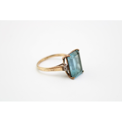 455 - A vintage 9ct gold, topaz and diamond set dress ring, the emerald stone of approximately 14.1 by 10.... 