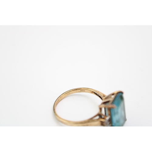 455 - A vintage 9ct gold, topaz and diamond set dress ring, the emerald stone of approximately 14.1 by 10.... 