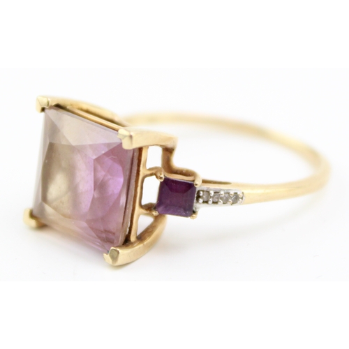 456 - A 9ct gold, tourmaline, amethyst and diamond dress ring, the large emerald cut tourmaline with disti... 