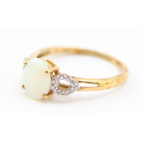 458 - A 10ct gold opal and diamond dress ring, set with oval opal of approximately 8.9 by 7.3mm, the heart... 