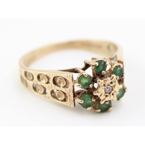 459 - A vintage 9ct gold emerald and diamond flowerhead ring in the Brutalist style, set with six emerald ... 