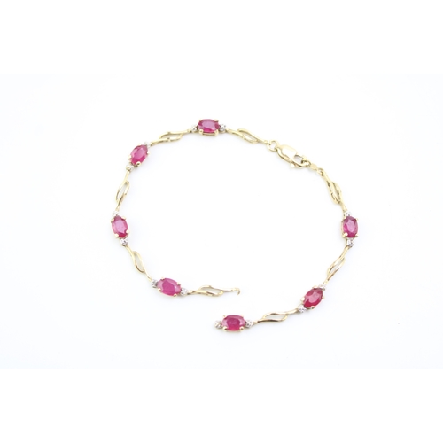 479 - A 9ct gold and ruby bracelet, set with seven oval cut rubies, 19cm long, a/f broken but both parts p... 